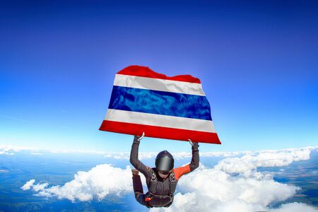 Thailand extreme. Flag in skydiving. People in free fall grab flag of Thailand. Patriotism, men and flag.の写真素材