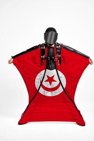 Tunisia extreme. Flag in skydiving. People in free fall grab flag of Tunisia. Patriotism, men and flag.の写真素材