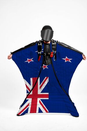 New Zealand extreme. Flag in skydiving. People in free fall grab flag of New Zealand . Patriotism, men and flag.の写真素材