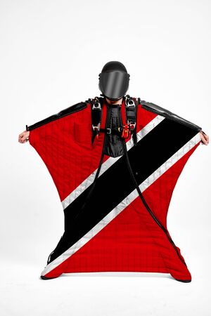 Trinidad and Tobago extreme. Flag in skydiving. People in free fall grab flag of Trinidad and Tobago. Patriotism, men and flag.の写真素材