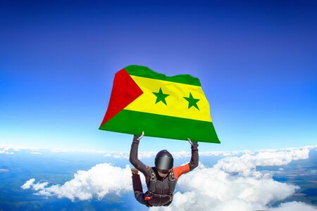 Sao Tome and Principe extreme. Flag in skydiving. People in free fall grab flag of Sao Tome and Principe. Patriotism, men and flag.の写真素材