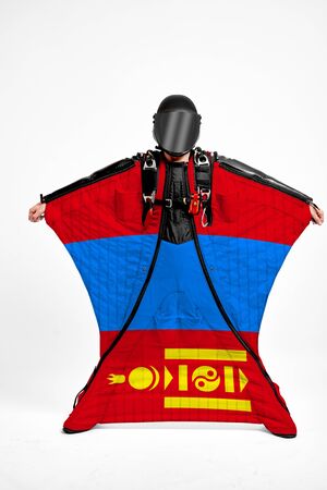 Mongolia extreme. Flag in skydiving. People in free fall grab flag of Mongolia. Patriotism, men and flag.の写真素材