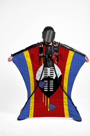 Esvatini extreme. Flag in skydiving. People in free fall grab flag of Esvatini. Patriotism, men and flag.の写真素材