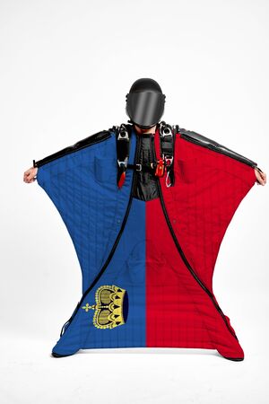 Liechtenstein extreme. Flag in skydiving. People in free fall grab flag of Liechtenstein. Patriotism, men and flag.の写真素材