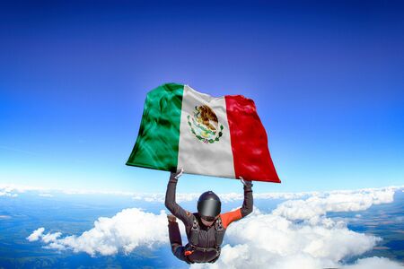 Mexico extreme. Flag in skydiving. People in free fall grab flag of Mexico. Patriotism, men and flag.の写真素材