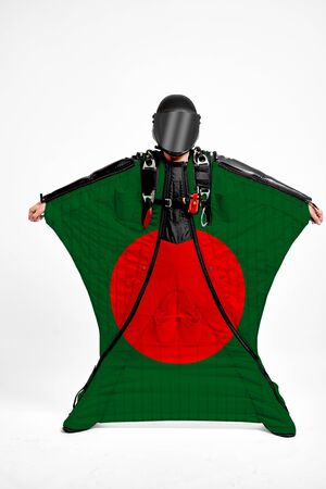 Bangladesh extreme. Flag in skydiving. People in free fall grab flag of Bangladesh. Patriotism, men and flag.の写真素材