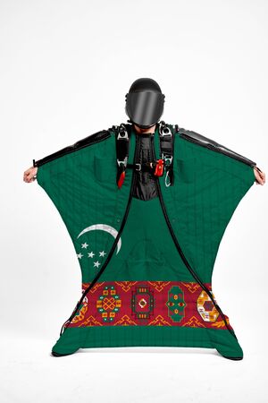 Turkmenistan extreme. Flag in skydiving. People in free fall grab flag of Turkmenistan. Patriotism, men and flag.の写真素材