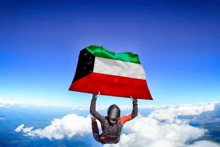 UAE extreme. Flag in skydiving. People in free fall grab flag of UAE. Patriotism, men and flag.の写真素材