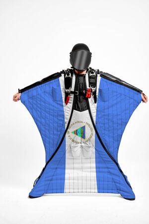 Nicaragua extreme. Flag in skydiving. People in free fall grab flag of Nicaragua. Patriotism, men and flag.の写真素材