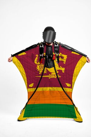 Sri Lanka extreme. Flag in skydiving. People in free fall grab flag of Sri Lanka. Patriotism, men and flag.の写真素材