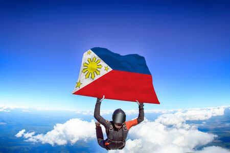Philippines extreme. Flag in skydiving. People in free fall grab flag of Philippines. Patriotism, men and flag.の写真素材