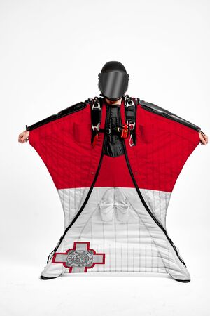 Malta extreme. Flag in skydiving. People in free fall grab flag of Malta. Patriotism, men and flag.の写真素材