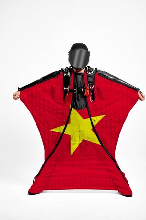 Vietnam extreme. Flag in skydiving. People in free fall grab flag of Vietnam. Patriotism, men and flag.の写真素材
