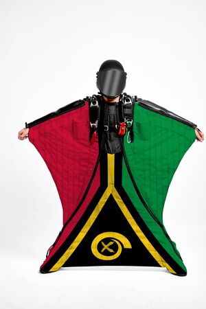 Vanuatu extreme. Flag in skydiving. People in free fall grab flag of Vanuatu. Patriotism, men and flag.の写真素材
