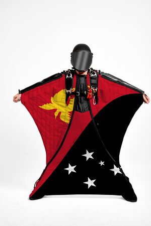 Papua New Guinea extreme. Flag in skydiving. People in free fall grab flag of Papua New Guinea. Patriotism, men and flag.の写真素材