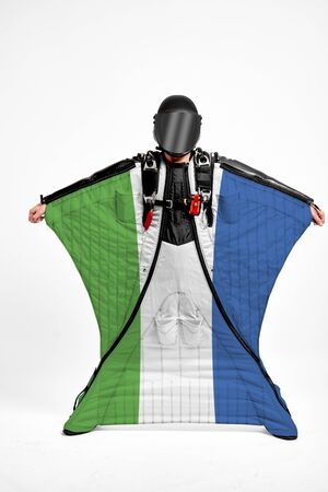 Sierra Leone extreme. Flag in skydiving. People in free fall grab flag of Sierra Leone. Patriotism, men and flag.の写真素材