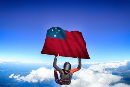 Samoa extreme. Flag in skydiving. People in free fall grab flag of Samoa. Patriotism, men and flag.の写真素材