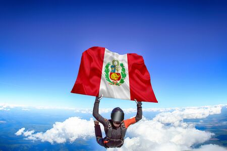 Peru extreme. Flag in skydiving. People in free fall grab flag of Peru. Patriotism, men and flag.の写真素材
