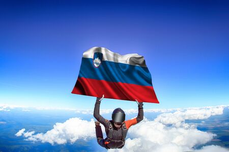 Slovakia extreme. Flag in skydiving. People in free fall grab flag of Slovakia. Patriotism, men and flag.の素材 [FY310134789637]