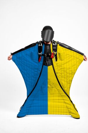 Ukraine extreme. Flag in skydiving. People in free fall grab flag of Ukraine. Patriotism, men and flag.の写真素材
