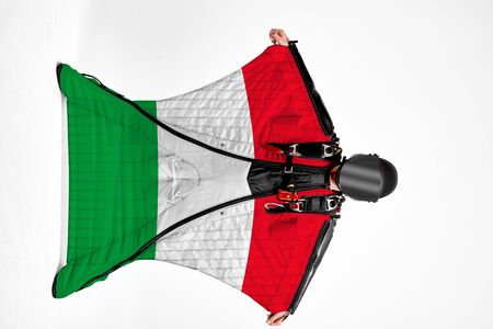 Italy flag. Men in wing suit templet. People in free fall grab flag of Italy. Patriotism, men and flag.の写真素材