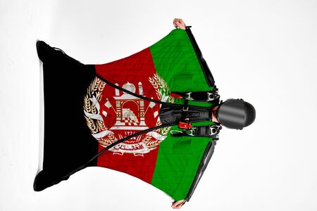 Afghanistan flag. Men in wing suit templet. People in free fall grab flag of Afghanistan. Patriotism, men and flag.の写真素材