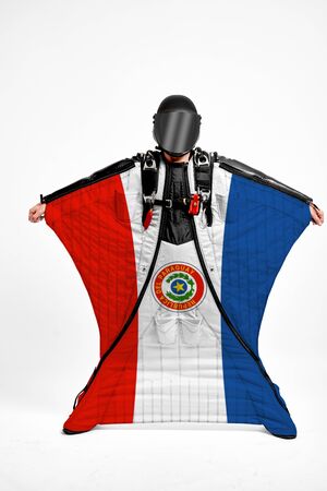Paraguay extreme. Men in wing suit templet. Skydiving men in parashute. Simulator of free fall.の写真素材