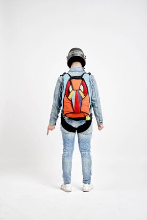 One finger. Men in parachute equipment and helmet show one finger. Teampleat skydiver.の写真素材