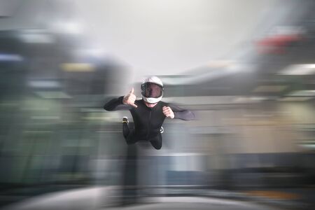 Three finfers. Men in parachute shows three fingers. Gesture by fingers. Skydiving sport.の写真素材