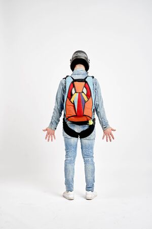 Ten fingers. Men in parachute shows ten fingers. Gesture by fingers. Skydiving sport.の写真素材