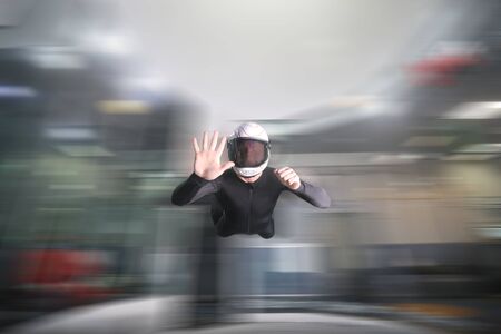 Five finfers. Men in parachute shows five fingers. Gesture by fingers. Skydiving sport.の写真素材