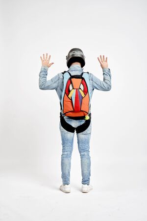 Nine fingers. Men in parachute shows nine fingers. Gesture by fingers. Skydiving sport.の写真素材