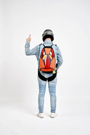 One finger. Men in parachute equipment and helmet show one finger. Teampleat skydiver.の写真素材
