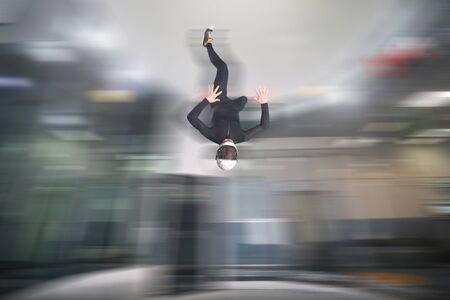 Ten fingers. Men in parachute shows ten fingers. Gesture by fingers. Skydiving sport.の写真素材