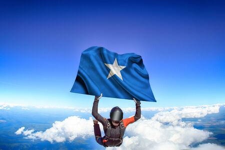 Somalia extreme. Flag in skydiving. People in free fall grab flag of Somalia. Patriotism, men and flag.の写真素材
