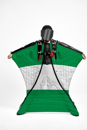 Nigeria extreme. Men in wing suit templet. Skydiving men in parashute. Simulator of free fall.の写真素材
