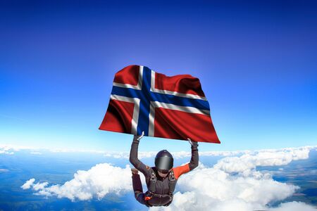 Norway extreme. Flag in skydiving. People in free fall grab flag of Norway. Patriotism, men and flag.の写真素材