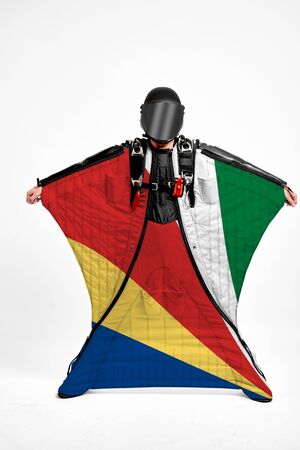 Seychelles extreme. Men in wing suit templet. Skydiving men in parashute. Simulator of free fall.の写真素材