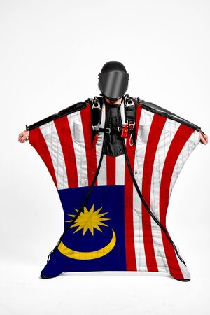 Malaysia extreme. Men in wing suit templet. Skydiving men in parashute. Simulator of free fall.の写真素材