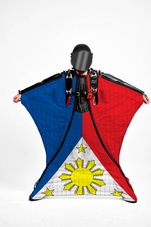 Philippines flag travel. Simulator of free fall. Men in wing suit.の写真素材