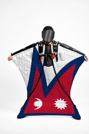 Nepal flag travel. Men in wing suit templet. Skydiving men in parashute. Simulator of free fall.の写真素材
