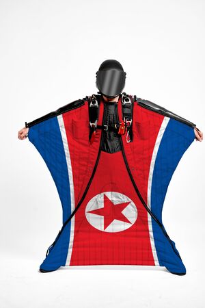 north korea extreme. Men in wing suit templet. Skydiving men in parashute. Simulator of free fall.の写真素材