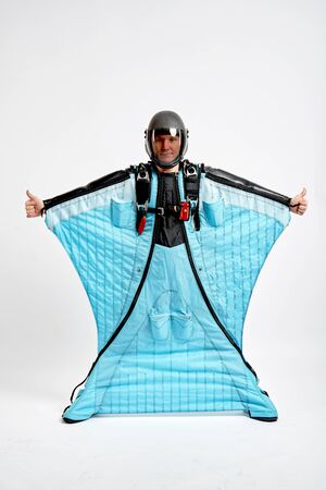 Class. Men in wing suit shows gesture of approval. Skydiving men in parashute. Simulator of free fall.の写真素材