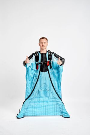 Class. Men in wing suit shows gesture of approval. Skydiving men in parashute. Simulator of free fall.の写真素材