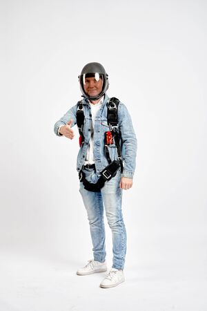 Greeting gesture. Fly men shows greeting gesture with hands. Sky diver gestures by fingers. Teampleat skydiver.の写真素材