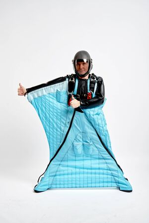 Class. Men in wing suit shows gesture of approval. Skydiving men in parashute. Simulator of free fall.の写真素材