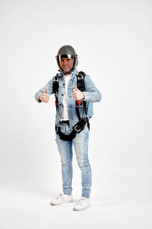 Class. Fly men shows gesture of approval. Sky diver gestures by fingers. Teampleat skydiver.の写真素材