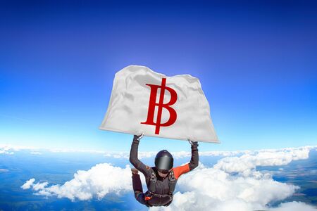 Bitcoin. Men in parachute equipment. Skydiving sport. Extreme hobby as a way of life. Parachuting. Men in free fall.の写真素材