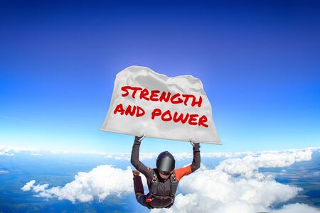 Strength and power. Men in parachute equipment. Skydiving sport. Extreme hobby as a way of life. Parachuting. Men in free fall.の写真素材