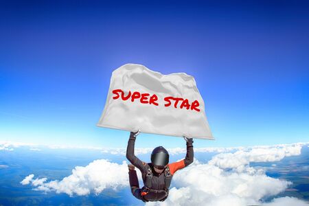 Super star. Men in parachute equipment. Skydiving sport. Extreme hobby as a way of life. Parachuting. Men in free fall.の写真素材